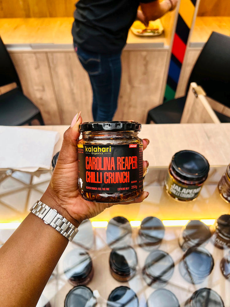 A jar of Carolina Reaper Chilli Crunch held up at the Kalahari Organics pop-up