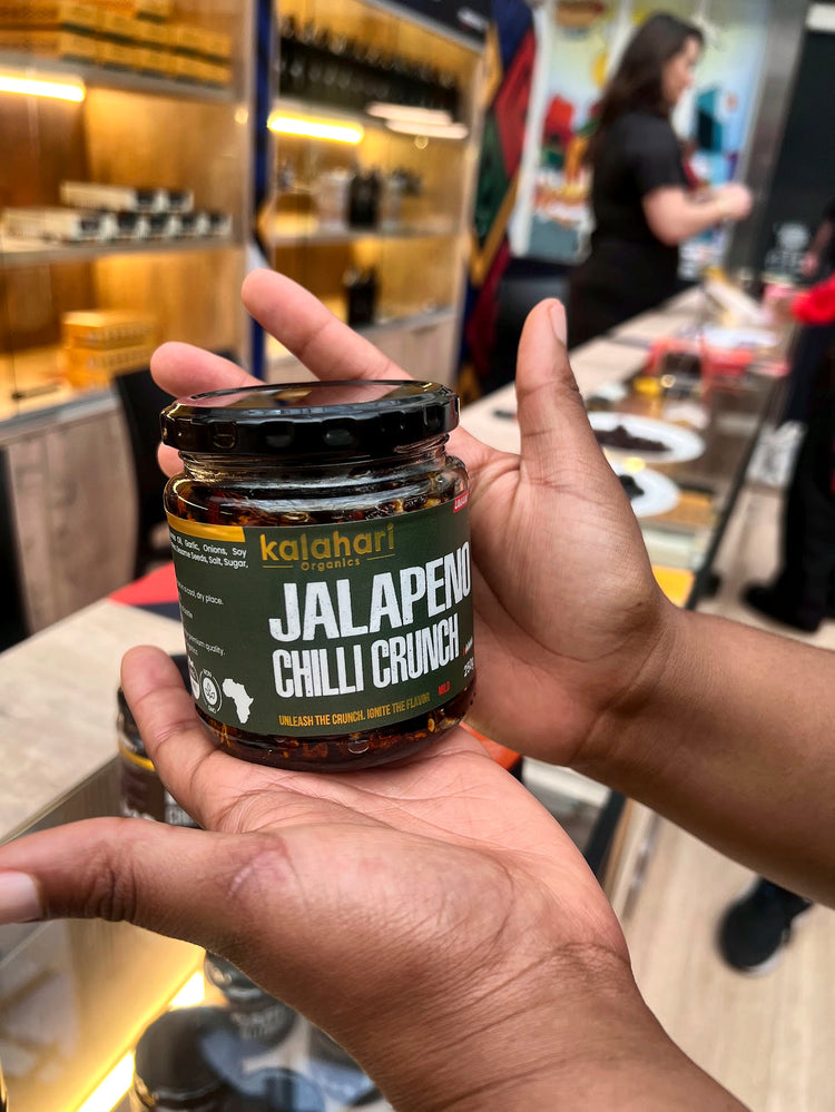A jar of Jalapeño Chilli Crunch held in open hands at the pop-up